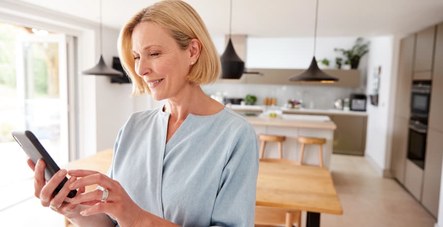 Homeowner using a smartphone in a stylish home
